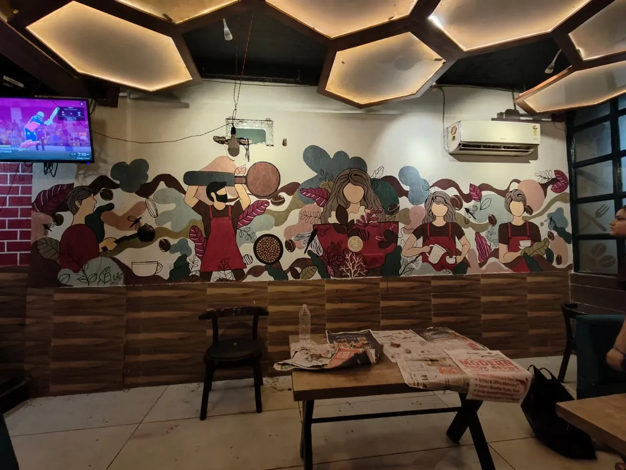 Completed coffee-themed mural on a cafe wall
