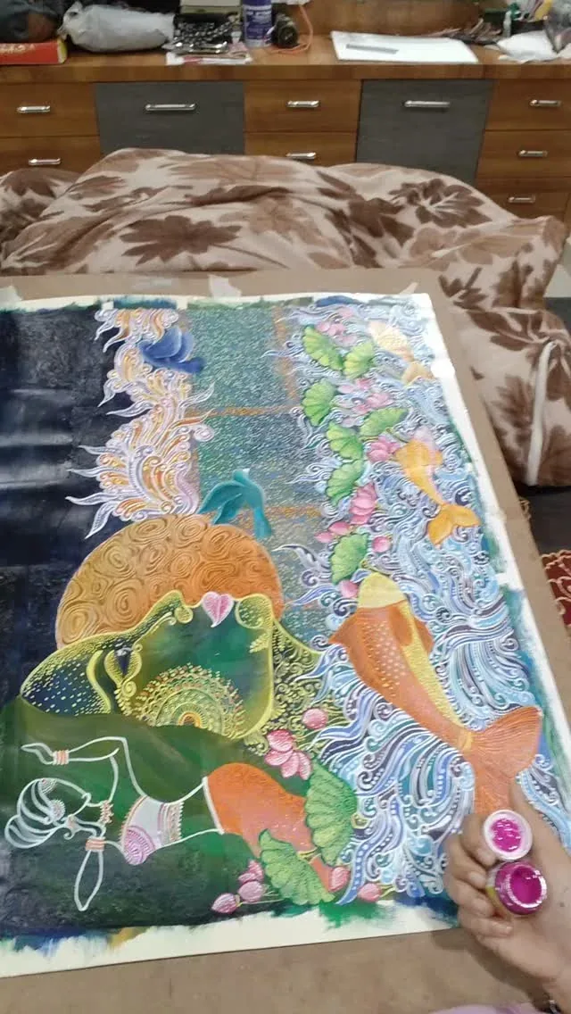 A painting in progress showing colourful figures and botanical details beside paint pots