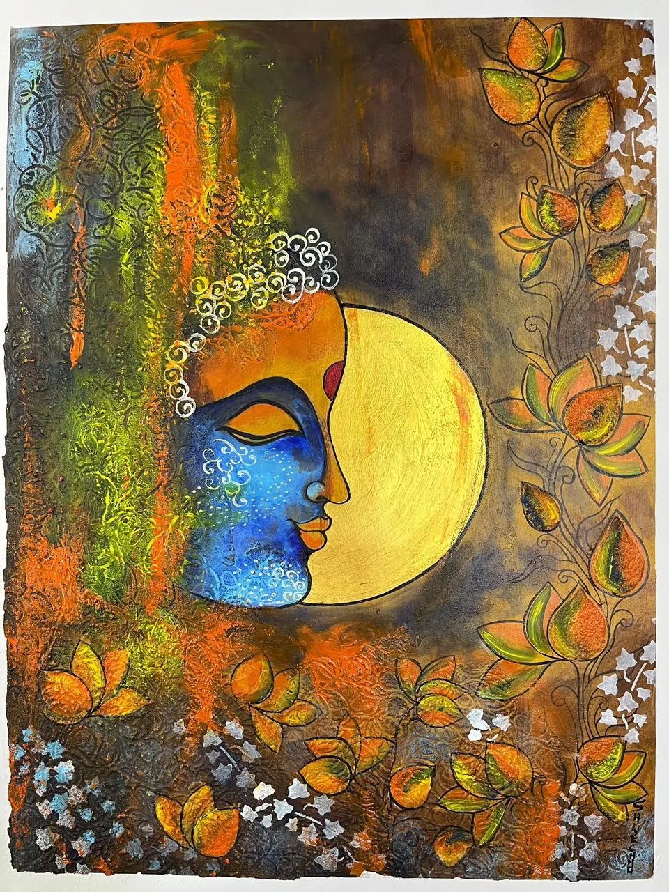 A painted blue face beside a yellow moon with floral details