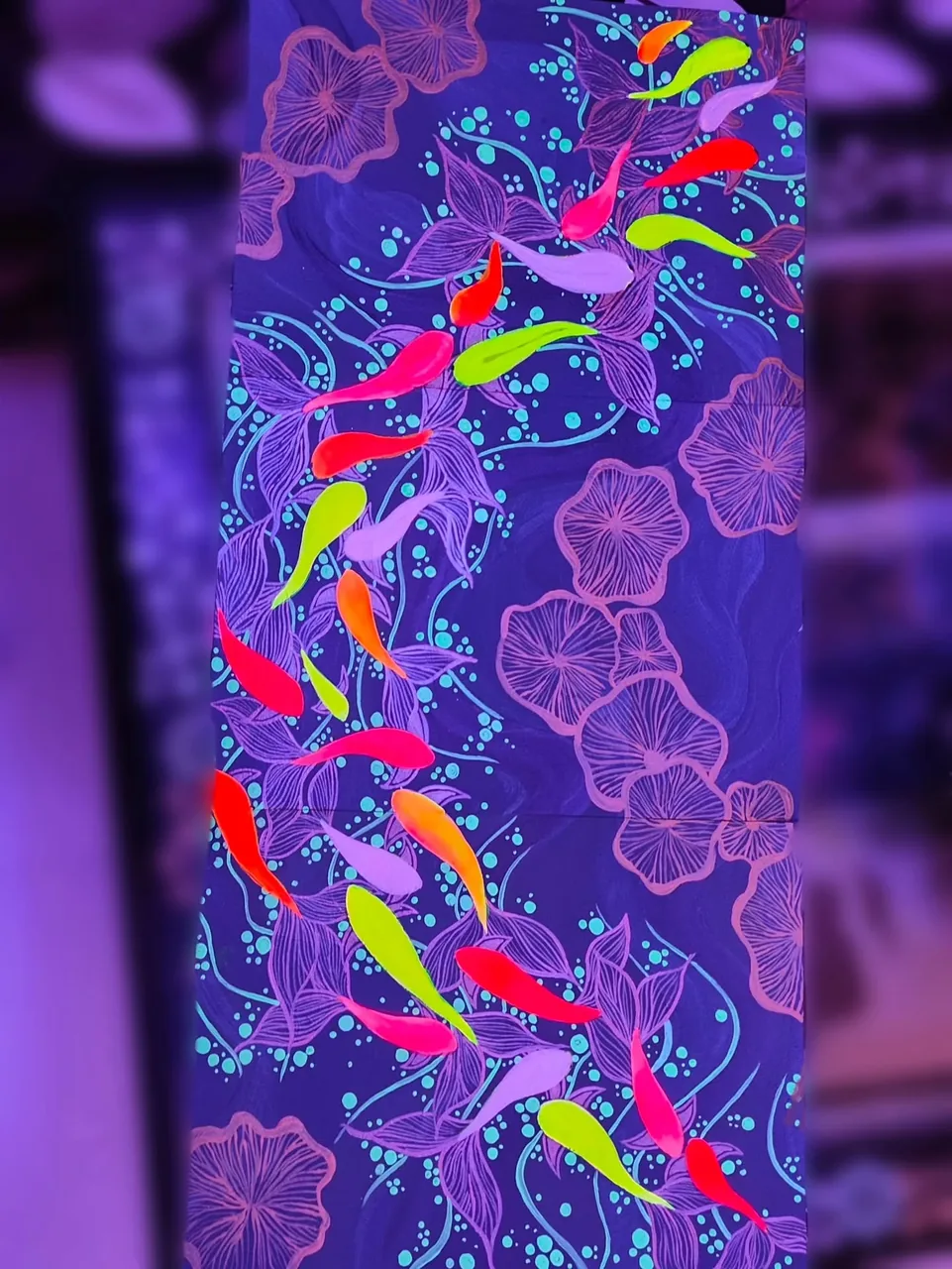 Bright pink, yellow and blue birds amid flowers against a purple background