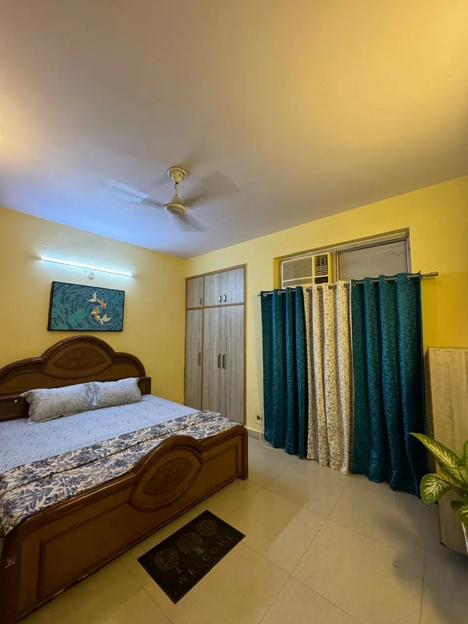Bedroom with a framed koi fish painting above the bed