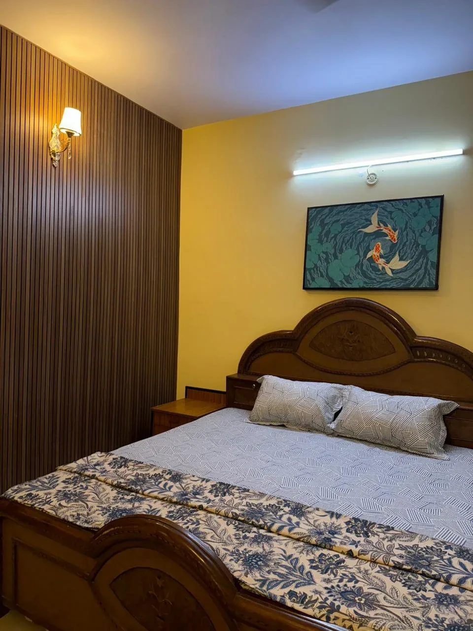 Close view of the koi fish painting above a wooden bed