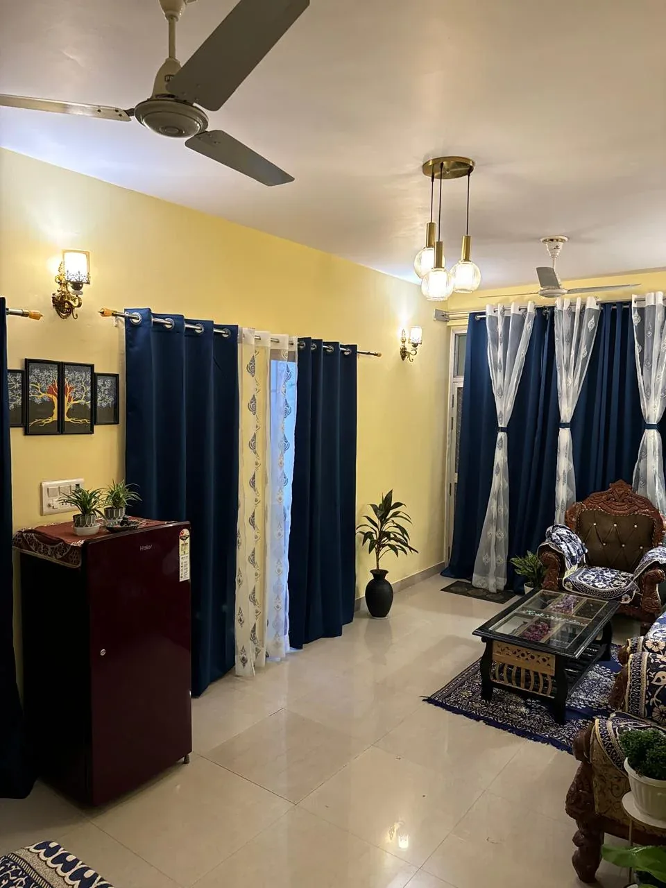 Wide view of the living room styled with plants and framed art